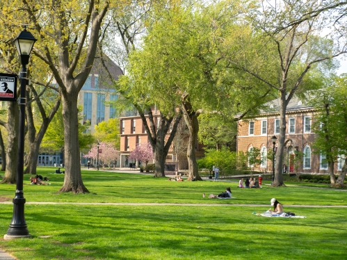 Students enjoy a warm spring day on Voorhees Mall on the College Avenue campus